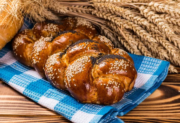 Assortment of baked bread on wood table — Stock Photo, Image