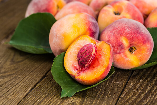 fresh peaches on wood background