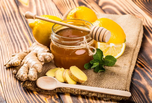 Honey with lemon and nuts. — Stock Photo, Image