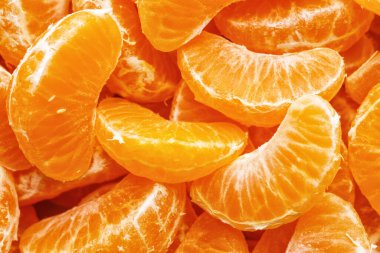 Tangerine segments, orange background texture,Flat lay, top view.healthy citrus fruits with lots of vitamins