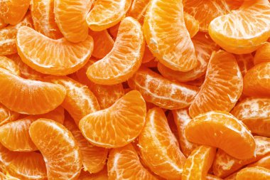 Tangerine segments, orange background texture,Flat lay, top view.healthy citrus fruits with lots of vitamins