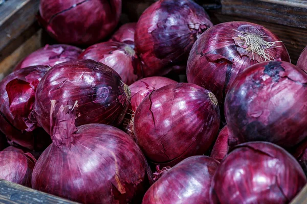 Red onions in plenty on display at local farmer\'s market, Big fresh red onions background.red onions on rustic wood