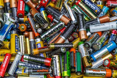Kiev. Ukraine. December 20, 2020. Used batteries from different manufacturers, waste, collection and recycling, high danger for the environment. Batteries background clipart
