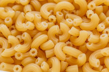 Kısa İtalyan pipo makarna. Makarna, erişte gibi buğday unundan yapılan İtalyan geleneksel makarnasıdır. Kuru makarna arka planı.