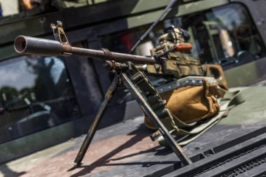 Machine gun Kalashnikov on the tripod and optical sight.M249 light machine gun with 7.62 mm cartridge belt.Military action in the world.