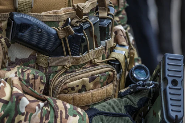Pistol in holster on belt of an armed man.Multicam camouflage. Topic: weapon, armed man, gun, military patrol. Man in camouflage is armed with pistol