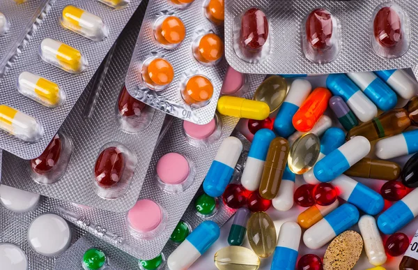 Medicamentos comprimidos e cápsulas em um copo — Fotografia de Stock