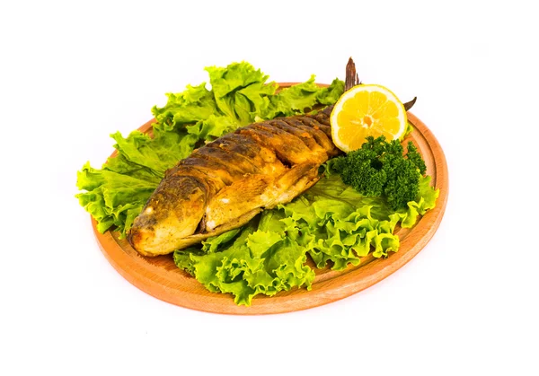 Fish with lemon, parsley on kitchen board on a white background — Stock Photo, Image