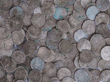 trove of ancient medieval coins silver background clipart