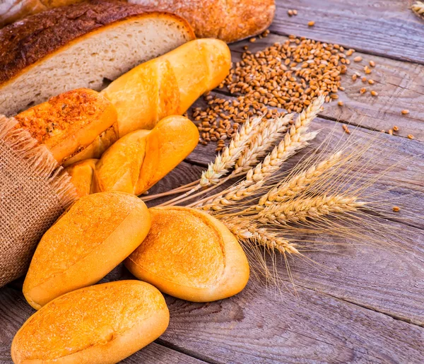 Fresh bread and wheat on the wooden — Stock Photo, Image