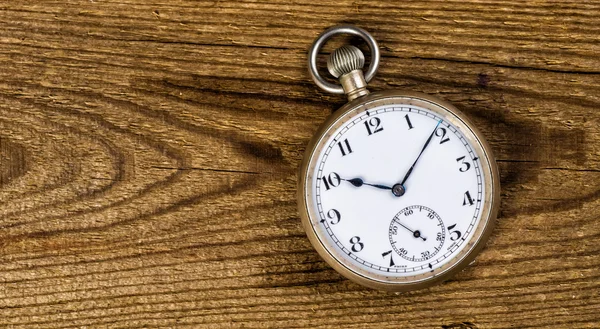 Old pocket watch and key on the wooden background with blank spa — Stock Photo, Image