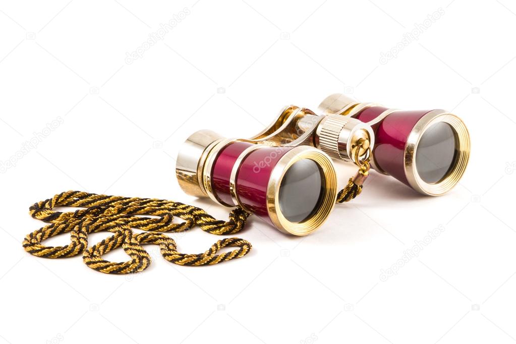 Red theater binoculars with golden cord on white background, isolated