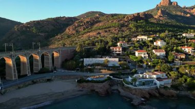 Saint Raphael, Fransız Rivierası yakınlarındaki Esterel Dağları 'ndaki Antheor Viaduct' ın hava panoramik manzarası, Akdeniz manzarası ve güneş doğarken Cote dAzur kıyı şeridi boyunca lüks villalar.