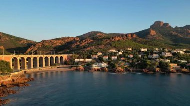 Saint Raphael, Fransız Rivierası yakınlarındaki Esterel Dağları 'ndaki Antheor Viaduct' ın hava panoramik manzarası, Akdeniz manzarası ve güneş doğarken Cote dAzur kıyı şeridi boyunca lüks villalar.