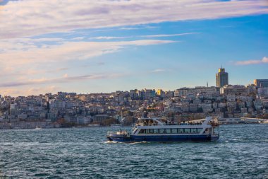 İstanbul 'un yoğun Avrupa yakasından geçen Boğaz feribotu, altın saat günbatımında gökyüzüne yükseliyor