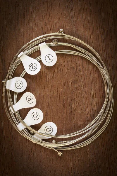 Guitar strings on wood background