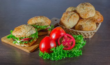 sandviç - hamburger burger, peynir, domates ve soğan ile ahşap arka plan üzerinde