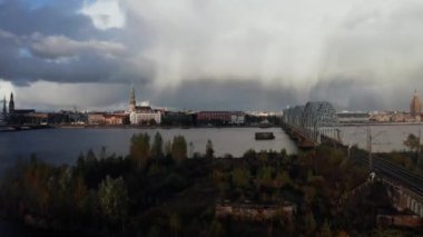 Riga, Letonya 'da gün batımında sağanak yağmur. Fırtınalı bulutlar ve gün ışığında hafif yağmurlarla Riga 'nın eski kasabasının hava manzarası. Şehrin üzerinde büyülü bir fırtına. Güzel Letonya.