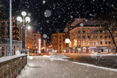February 10, 2021. Riga, Latvia. Beautiful winter night in the old town of Riga, Latvia. Statue of liberty Milda covered in snow at night.