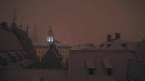 Heavy snowing in Riga over old town at night. Snowfall over the city. — Stock Video