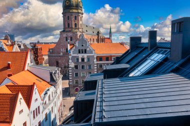 Riga, Latvia. May 01, 2021. Beautiful aerial view of the Riga old town with St. Peters cathedral in the center and epic sunset sky.