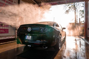 Araba yıkamada siyah Ford Mustang kaslı araba.