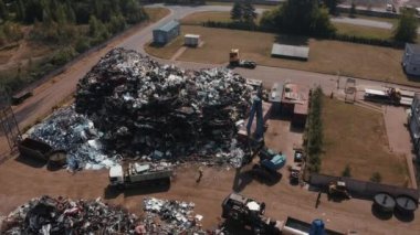 Old wrecked cars in junkyard waiting to be shredded in a recycling park