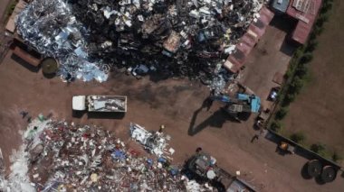 Old wrecked cars in junkyard waiting to be shredded in a recycling park