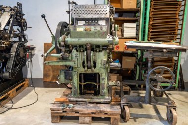 Old typography printing machine with letter samples.