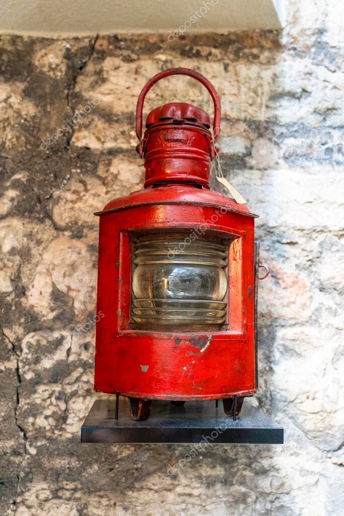 Old ship red lantern hanging on the wall.