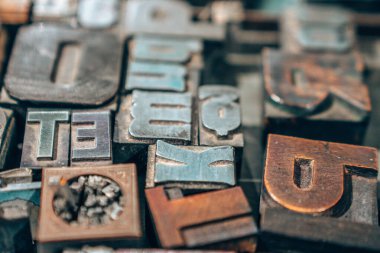 Old typography printing machine with letter samples.