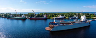 Cargo ship at floating dry dock is being renovated