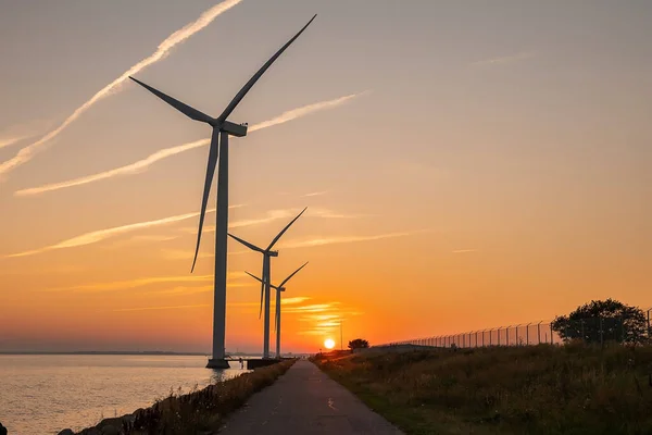 Wind turbines at sunset. Green ecological power energy generation.