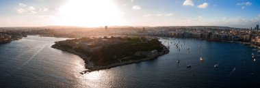 Hava görüntülerine göre Valletta Malta, Grand Harbour ve Marsamxett Limanı, kale duvarları, kireçtaşı binalar, kilise kubbeleri ve sakin sulardaki teknelerle birlikte..