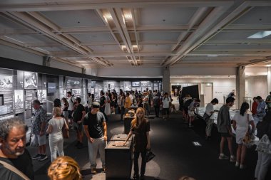 Hiroşima 'daki Hiroşima Barış Anıtı Müzesi' ndeki yoğun galeride ziyaretçiler aydınlatılmış panelleri okuyor ve tarihi aktaran satırları inceliyor..