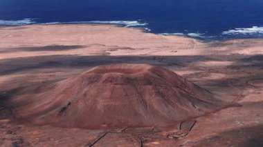 Hava aracı taraması krater, lav yamaçları, taş kaplamaları, toprak izleri ve Fuerteventura 'da Atlantik kıyısındaki kıyı sahanlığı olan kırmızı koni gösteriyor..