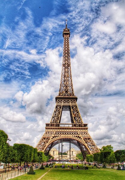 PARIS, FRANCE - CIRCA JULY, 2015. The popular tourist attraction of The Eiffel Tower in Paris, France on a bright summer day with blue sky and white clouds.