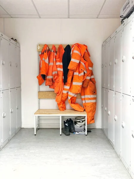 A construction or railway worker locker room with hi viz safety wear