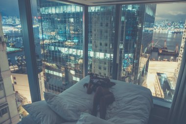 Young attractive woman making selfie in the bed at night