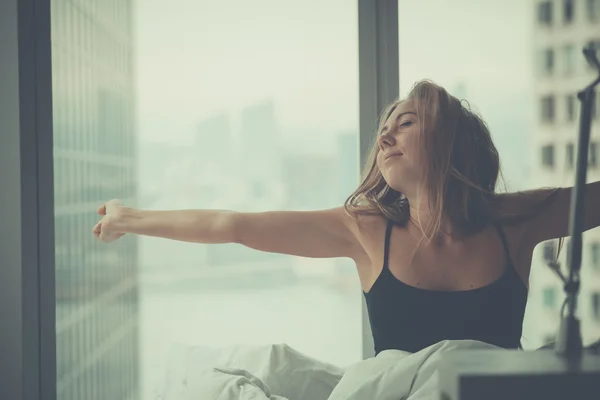 Young attractive woman in bed in the morning — Stok fotoğraf