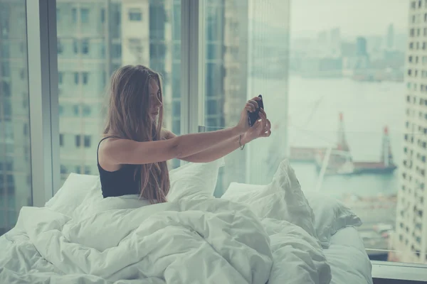 Young woman making self portrait in the morning — Stok fotoğraf