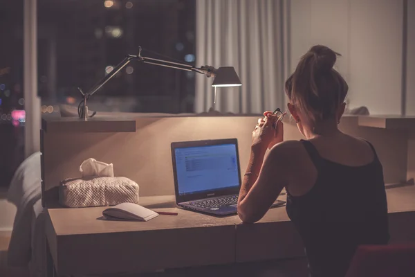 Young woman overworking in the office