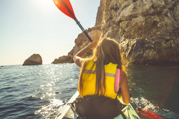 Young girl kayaking alone