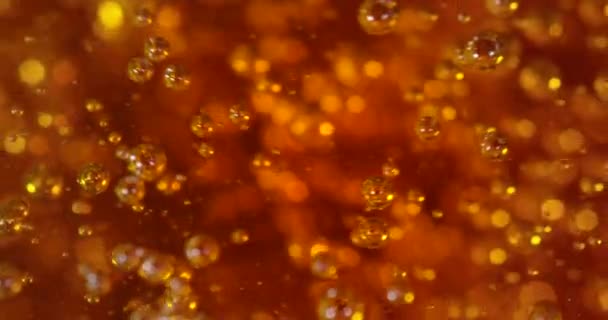 Närbild skott av hälla gul gyllene vätska i slow motion. Abstrakt makro av öl, honung eller olja. — Stockvideo
