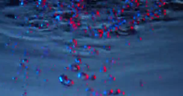 Air bubbles colored in blue and red rising up on blue background. — Stock Video