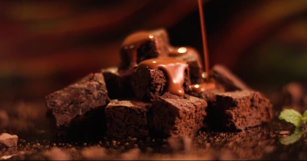 Nalít čokoládovou omáčku na čokoládový zákusek. Blízko koláče se sušenkami. Snímek pořízen zpomaleně pomocí RED kamery.. — Stock video