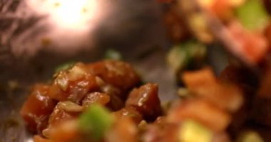 Şef somon tartare için malzemeleri karıştırıyor. Çiğ somon yemeği pişirirken yakın çekim. Kırmızı kamerayla ağır çekimde çekildi..