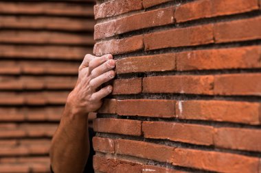 Climbing  a red brick wall clipart