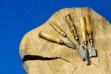 Chisels on wooden trunk clipart