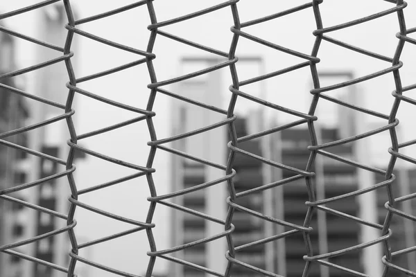 Wire mesh and skyscrapers — Stock Photo, Image